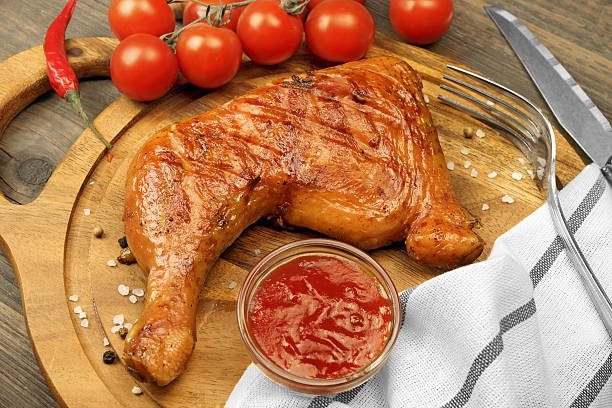 istock Grilled BBQ Chicken Leg Quarter On Wood Board, Top View 523702850