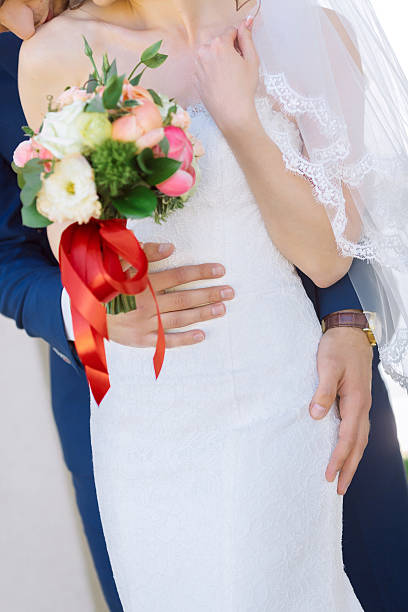 istock Groom hug bride with wedding bouquet 523703250