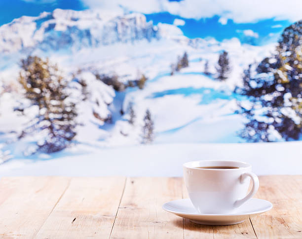 istock cup of coffee over winter landscape 523706229