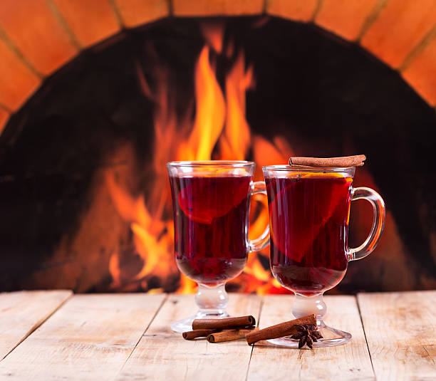 istock glasses of mulled wine  over fireplace 523706235