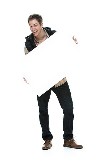istock Cheerful man holding placard & showing 523706613