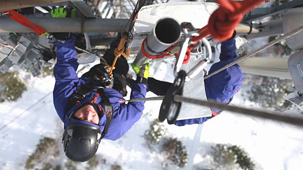 istock Two telecommunication manual high worker engineers repairing antenna 523707055