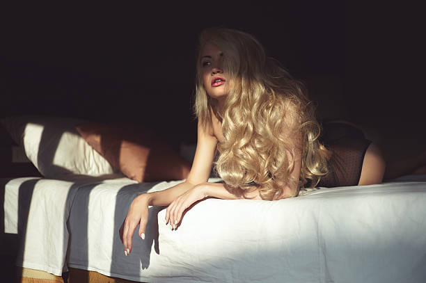 istock Blonde in bed in the sun 523708839