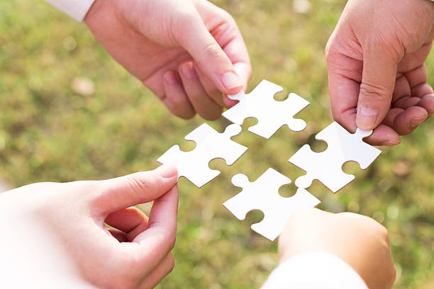 istock puzzle jigsaw and concept with meadow background 523709837