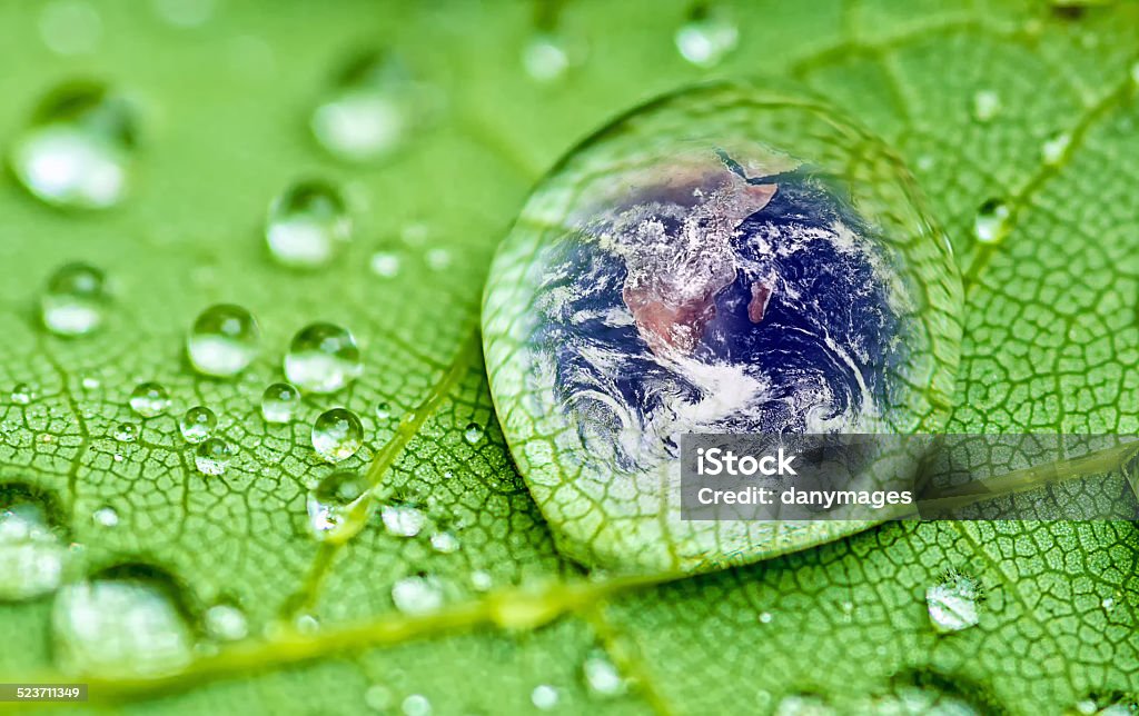 Raindrop planet earth inside a raindrop closeup on a green leaf , Water Stock Photo