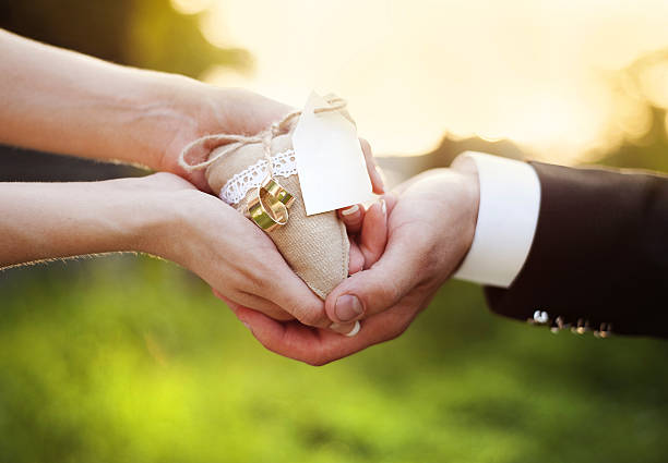 istock Bride and groom holding decorative heart in hands 523713833