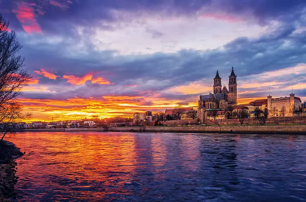 Glowing sunset over ther river Elbe and Magdeburg´s Cathedral (Magdeburger Dom) on winter evening