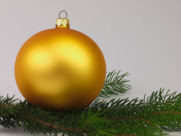 istock Golden bauble Christmas Tree with green twig. 523722829