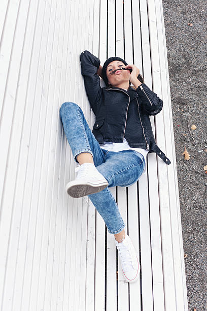 istock Beautiful young female lying on a park bench 523723741