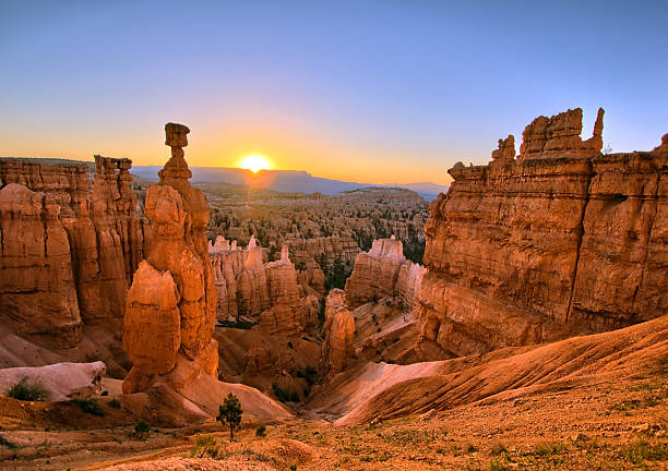 Bryce Canyon Sunrise The sun rising above Thor's Hammer at Bryce Canyon National Park, Utah.   rock formation photos stock pictures, royalty-free photos & images