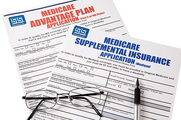 istock Medicare Applications with glasses and pen, isolated 523726795