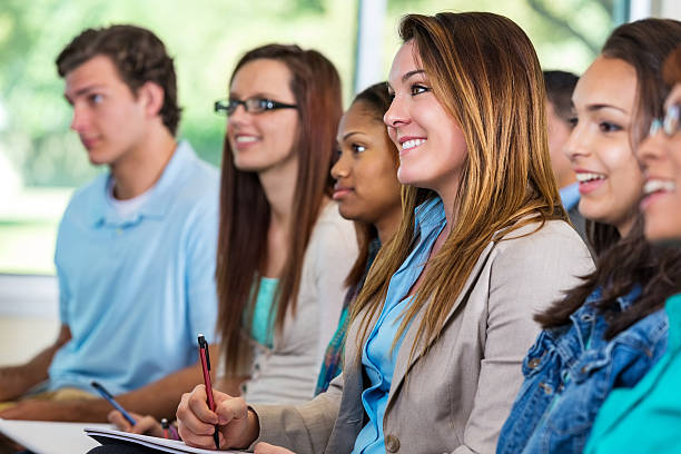 istock Young woman taking notes while listening to seminar speaker 523734009