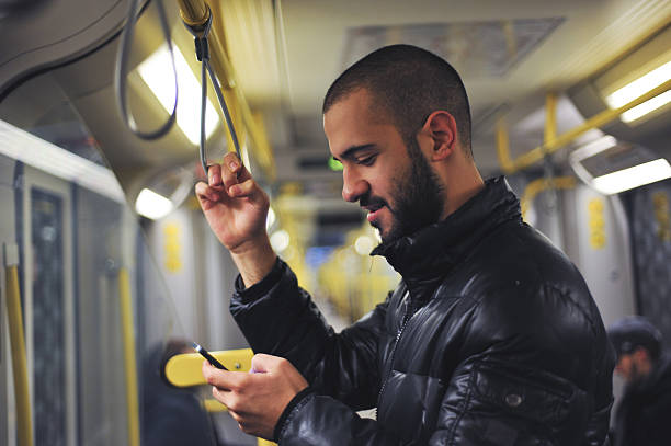 istock Young man looking at his smartphone in train 523734301