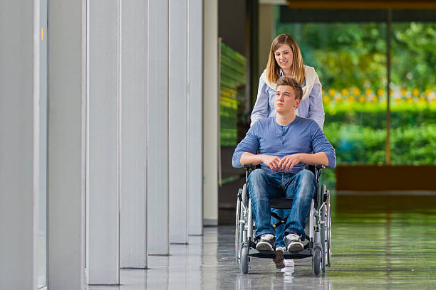 istock Young Man in Wheelchair talking with Girlfriend 523734941