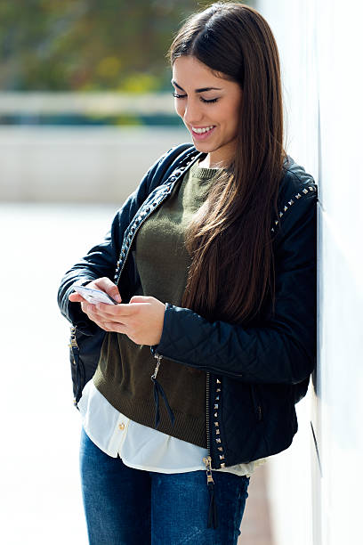istock Beautiful girl using her mobile phone in city. 523735885