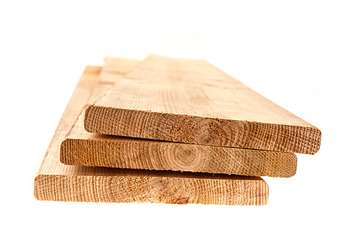 Three cedar one by six inch wood planks on white background