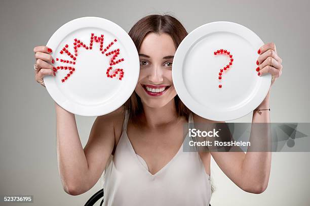 Young Woman Showing Plates Stock Photo - Download Image Now - Adult, Adults Only, Beautiful Woman