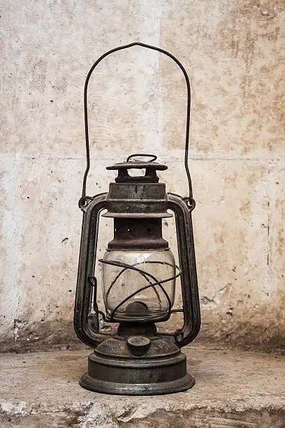 Old fashioned oil lamp, obselete metal lantern at historical place