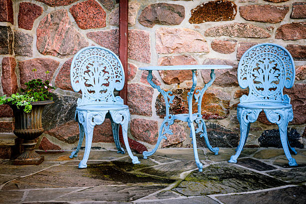 Blue painted metal outdoor furniture on stone patio