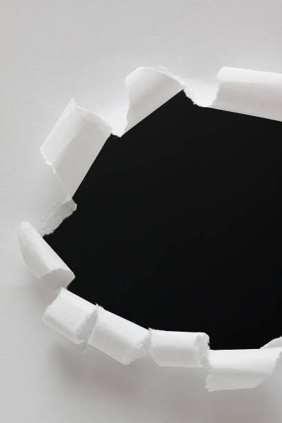 istock Torn paper hole background textured isolated on black 523739153