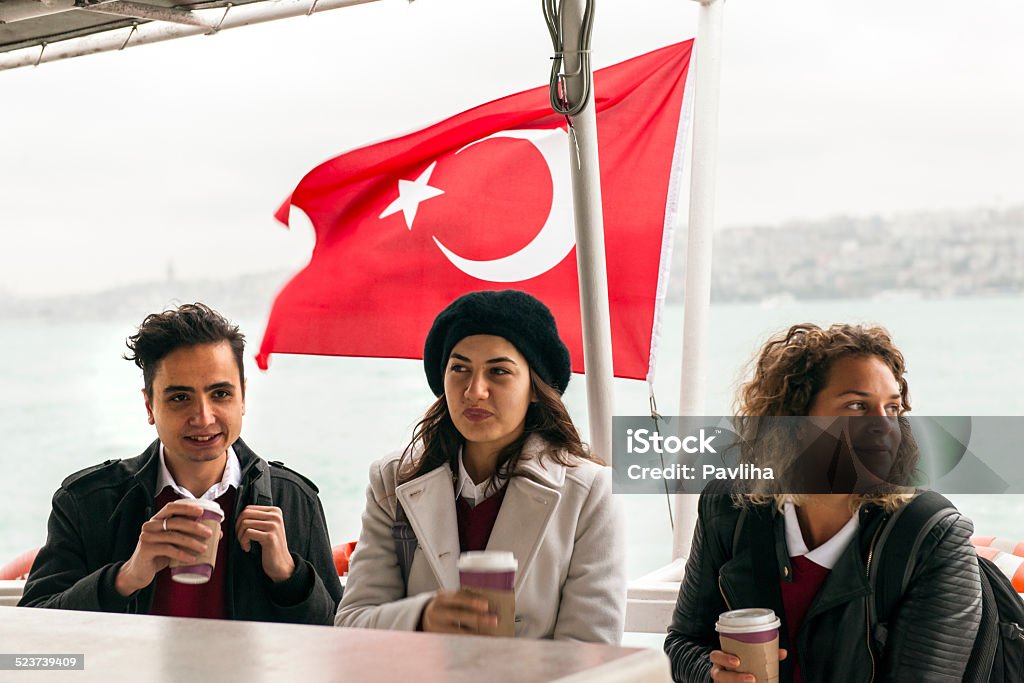 Happy Turkish Students on Ferryboat, Commuting to School, Morning, Istanbul Turkish students laughing on the ferry over Bosporus, going to school. Cold autumnal morning. Nikon D3x, full frame, XXXL. High iso. 18-19 Years Stock Photo