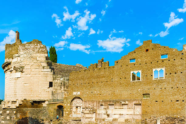 Rome, Italy - September 18, 2014: Tourists are visiting the Tomb of Caecilia Metella. It is a mausoleum located just outside of Rome at the three mile marker of the Via Appia. It was built during the 1st century B.C to honor Caecilia Metella who was a wife of Marcus Licinius Crassus, son of the famous Marcus Crassus who served under Julius Caesar.