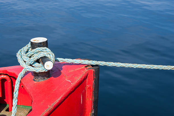 istock Mooring bollard with blue rope in marina. 523739931