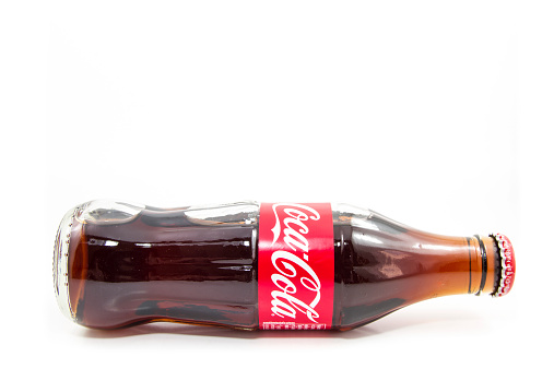 Сhiang Mai, Thailand - October 23, 2014: Coca-Cola classic glass bottle isolated on white background. Coca-Cola is the most well-known soft drink in the world.