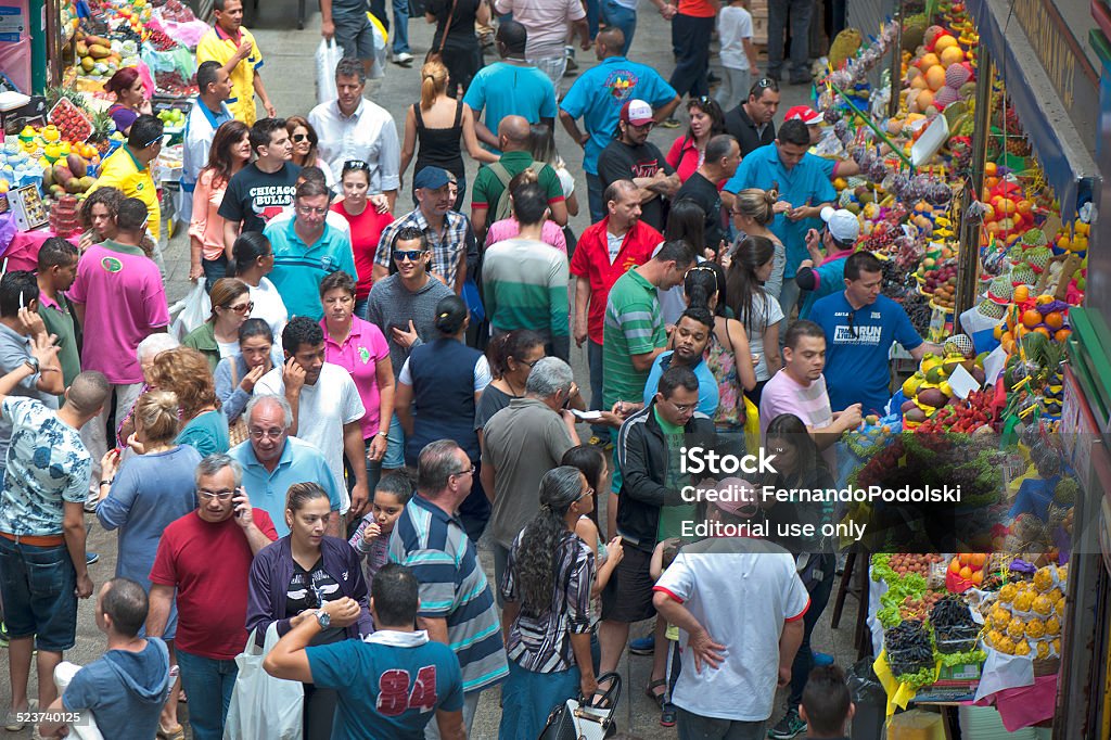 Municipal Market Sao Paulo, Brazil - November 16, 2014: Buyers circulate among the booths of the Mercado Municipal in the city of Sao Paulo in Brazil. The market built in 1930 is one of the attractions of the city and handles about 350 tons of food per day Architecture Stock Photo