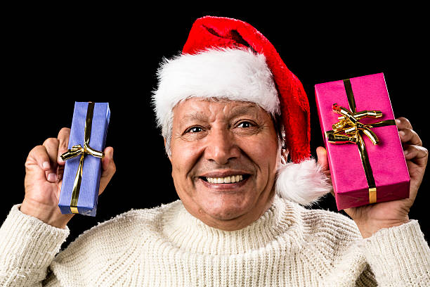 istock Euphoric Old Man With Two Presents And Santa Hat 523741641