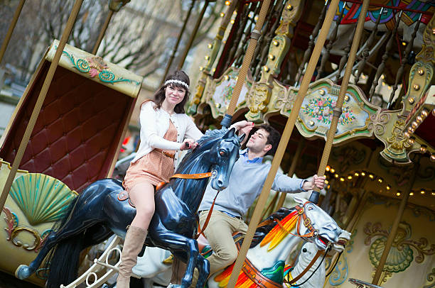 Couple having fun on merry-go-round