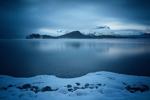 istock Snow Covered Shore on a Mountain Lake 523752461