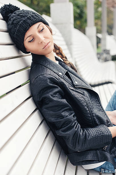 istock Beautiful young female sitting on the bench park 523753001