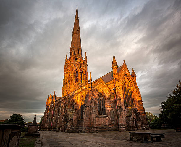 Gothic style church illuminated in the golden color of setting sunlight, Warrington , Cheshire, UK
