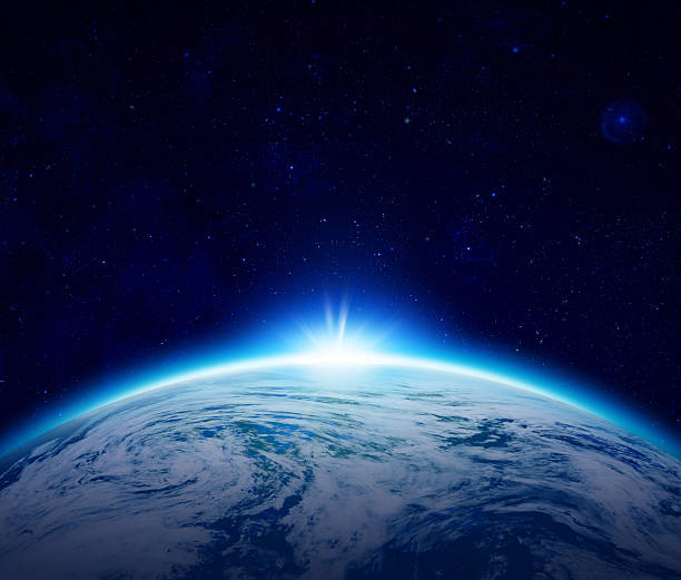 istock Blue Planet Earth sunrise over cloudy ocean with stars 523753025