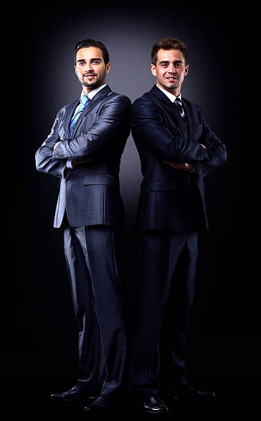 istock Two young businessmen full body, isolated on black 523756249