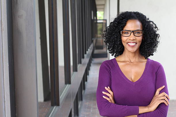 African american woman wearing glasses at work A pretty African american woman wearing glasses at work. assistant photos stock pictures, royalty-free photos & images