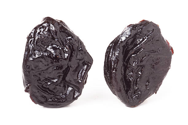 istock two dried prunes isolated on a white background closeup macro 523763374