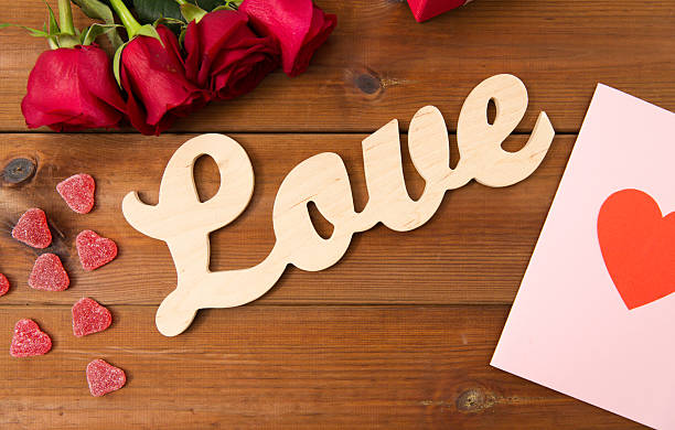 istock close up of gift box, red roses and greeting card 523768220