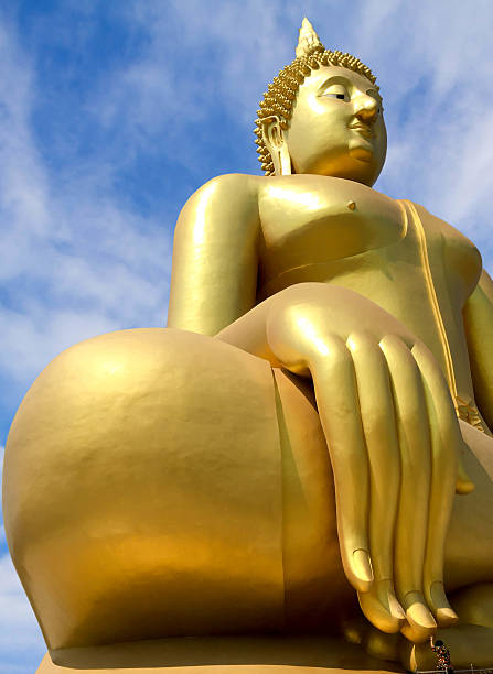 istock Big golden Buddha statues and people in blue sky 523770136