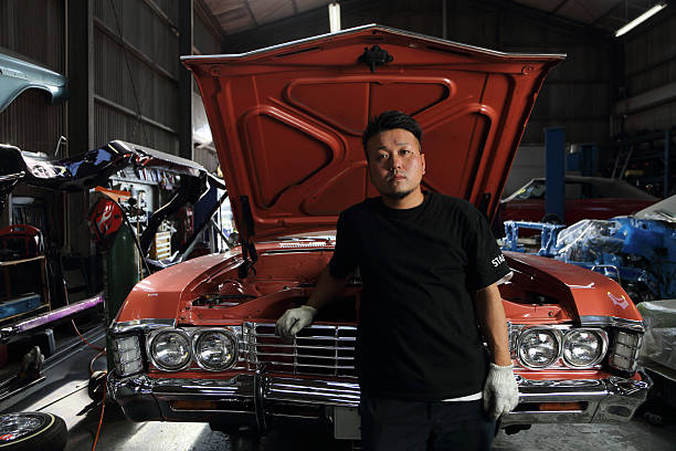 People working in car repair shop