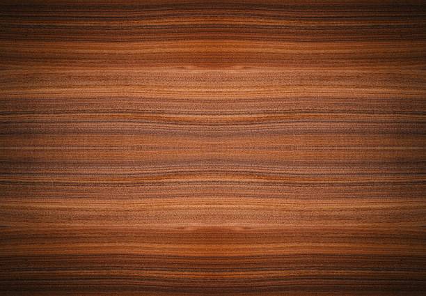 A fading, water-stained, brown wood paneled floor with diagonal slats.