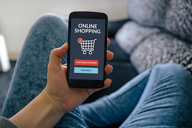 istock Hand holding smartphone with online shopping concept on screen 523773508