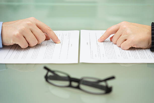 man and wife are reading divorce agreement stock photo