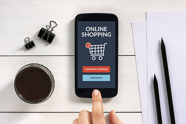 istock Online shopping concept on smart phone screen with office objects 523773882