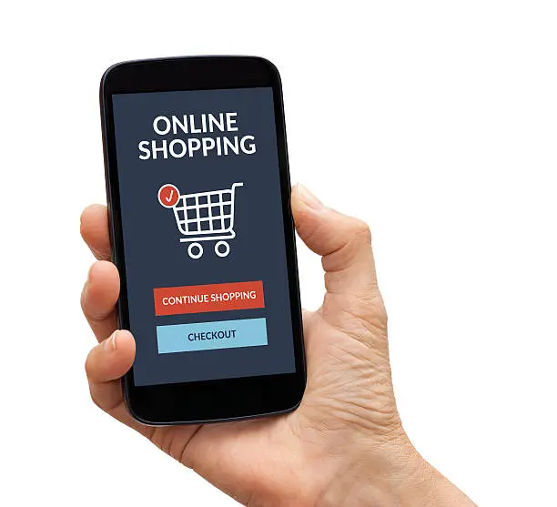 Photo of Hand holding smart phone with online shopping concept on screen