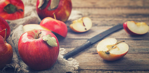 istock Fresh red apples on wooden background 523775290