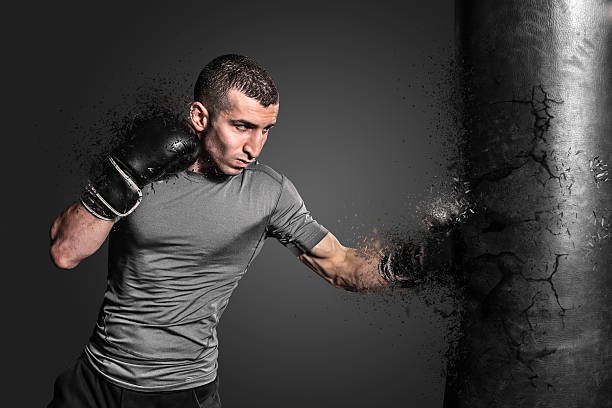 istock Boxer punching bag blow to the explosion 523776474