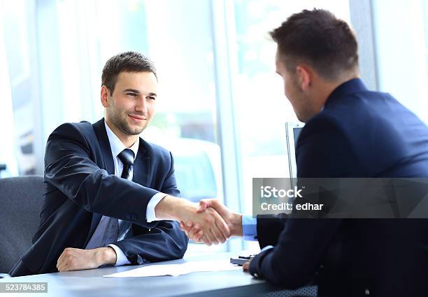 Businessman Shaking Hands To Seal Stock Photo - Download Image Now - Adult, Agreement, Attitude