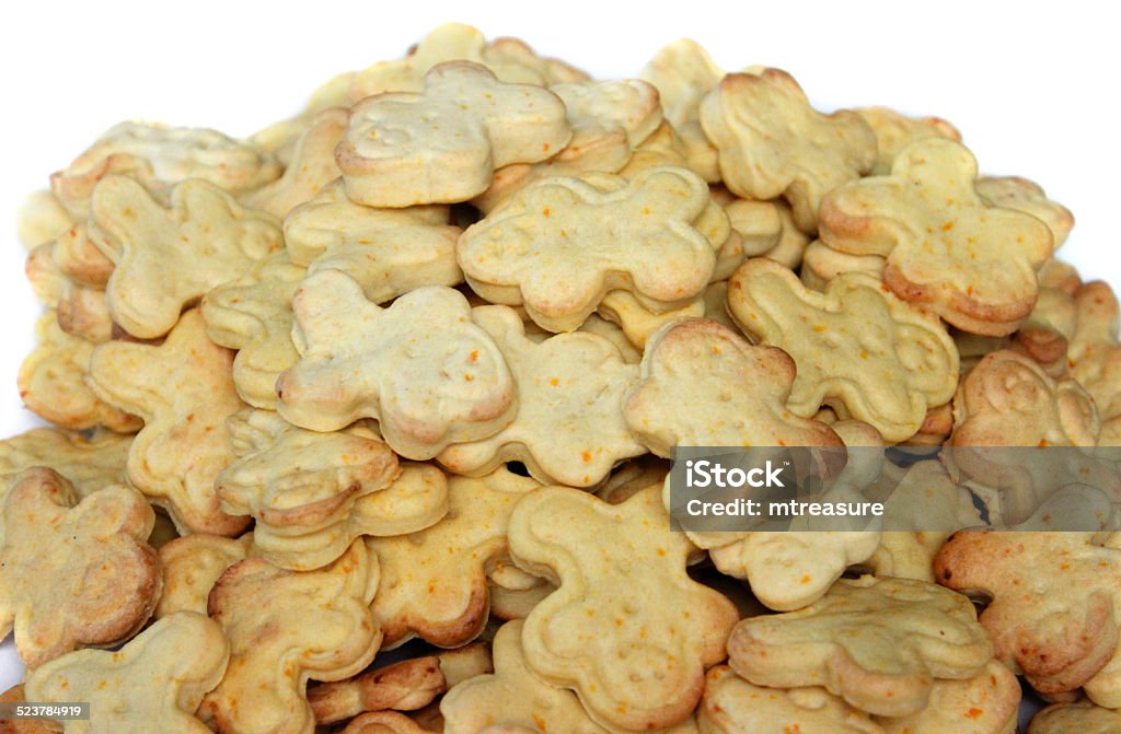 Freshly baked carrot and ginger gingerbread men biscuits / cookie-cutters, moulded Photo showing some freshly baked carrot and ginger gingerbread men biscuits, pictured piled high in a heap, on a white plate.  The gingerbread men have been cut out with a cookie cutter plunger mould.  Grated carrot has been added to the cookie mixture, along with cinnamon powder, to add a healthy element to this traditional sweet cut-out biscuit. Adult Stock Photo